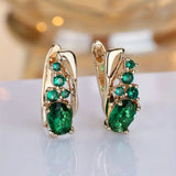 Boucles d'oreilles pendantes en or et émeraudes — Groumia